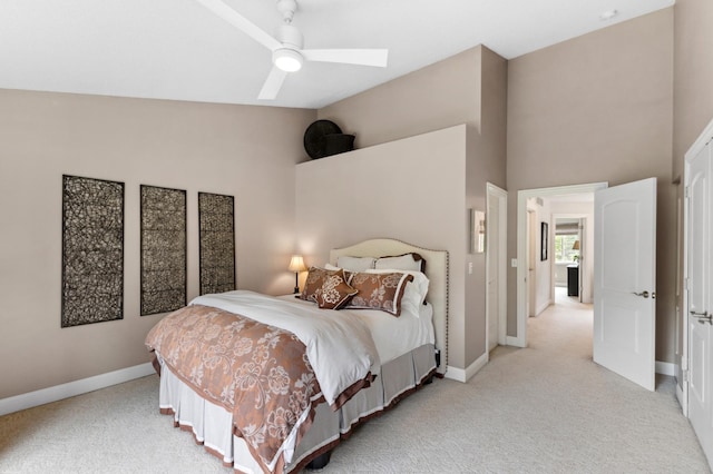 2244 Water Lilly Ln Unit 405, Eagan, MN 55122 - bedroom with light carpet, baseboards, a skylight, a ceiling fan, and a towering ceiling