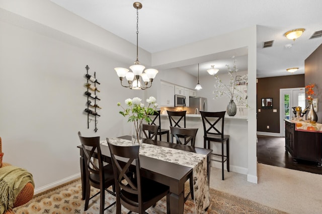 2244 Water Lilly Ln Unit 405, Eagan, MN 55122 - dining space with a chandelier, baseboards, and light carpet