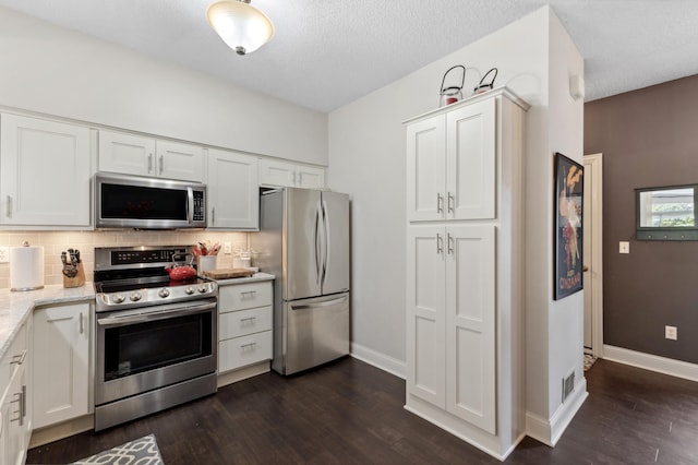2244 Water Lilly Ln Unit 405, Eagan, MN 55122 - kitchen with stainless steel appliances, decorative backsplash, dark wood-type flooring, white cabinets, and a textured ceiling