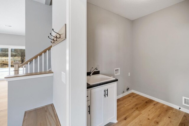 7773 Gunner Dr, Clear Lake, MN 55319 - washroom with washer hookup, light wood-style flooring, and baseboards