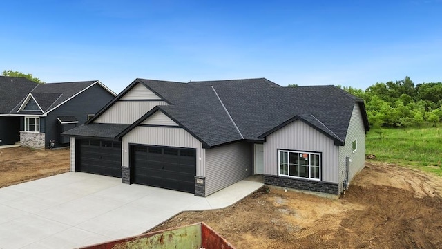 7773 Gunner Dr, Clear Lake, MN 55319 - modern farmhouse style home with a garage, stone siding, a shingled roof, and driveway