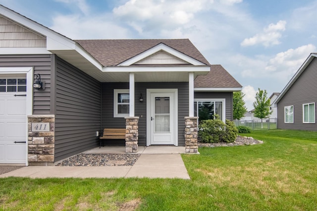 411 Ladd Ln, Osceola, WI 54020 - view of front of house with roof with shingles, stone siding, and covered porch