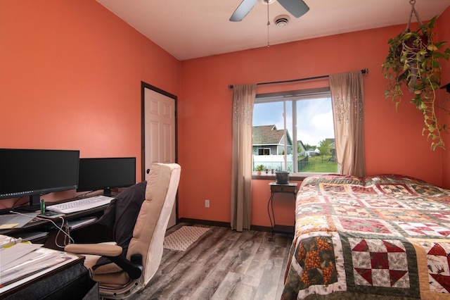 411 Ladd Ln, Osceola, WI 54020 - bedroom featuring wood finished floors, ceiling fan, and a desk