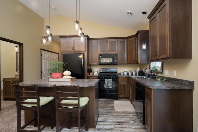 411 Ladd Ln, Osceola, WI 54020 - kitchen with black appliances, vaulted ceiling, a kitchen island, a breakfast bar, and light wood-style flooring