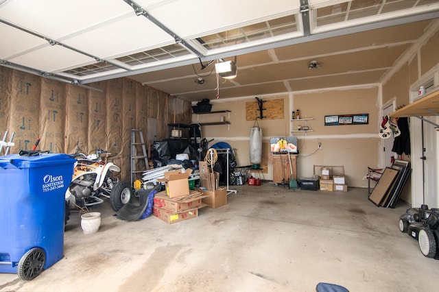 411 Ladd Ln, Osceola, WI 54020 - garage with a garage door opener and wooden walls