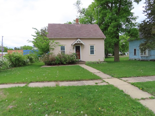 529 1st St N, Truman, MN 56088 - view of front of property featuring a front lawn and a chimney