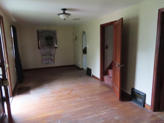 529 1st St N, Truman, MN 56088 - hall featuring arched walkways, light wood-type flooring, and stairs