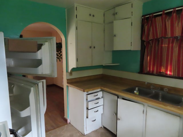 529 1st St N, Truman, MN 56088 - kitchen featuring a sink and arched walkways