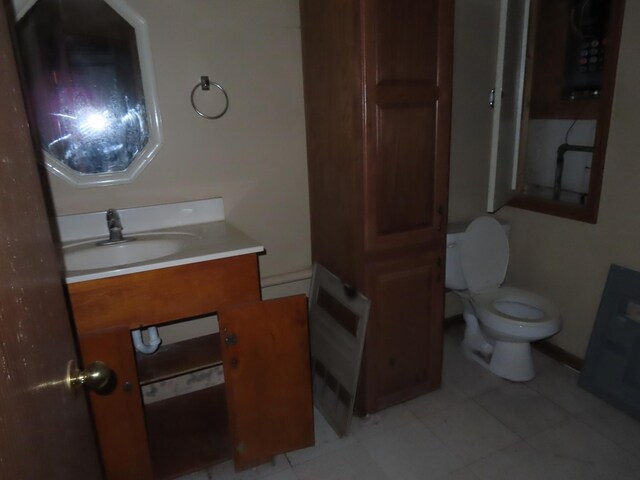 529 1st St N, Truman, MN 56088 - half bathroom with toilet, tile patterned flooring, and vanity