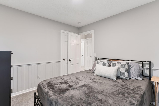 2505 Florida Ave N, Golden Valley, MN 55427 - carpeted bedroom with a wainscoted wall and a textured ceiling
