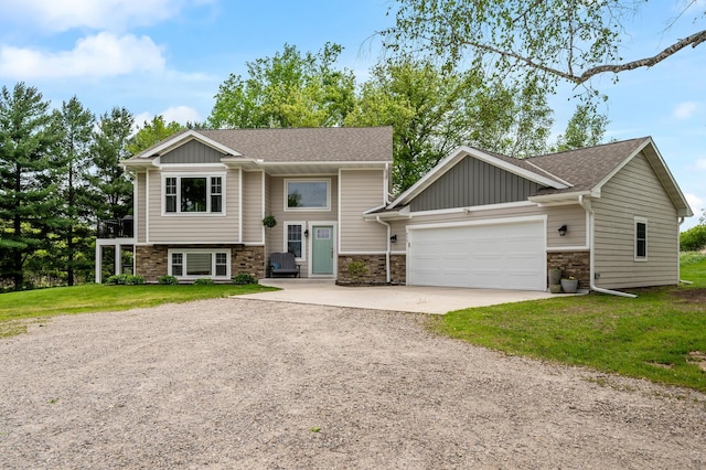 975 100th St NE, Monticello Twp, MN 55362 - bi-level home featuring dirt driveway, stone siding, an attached garage, a front yard, and board and batten siding