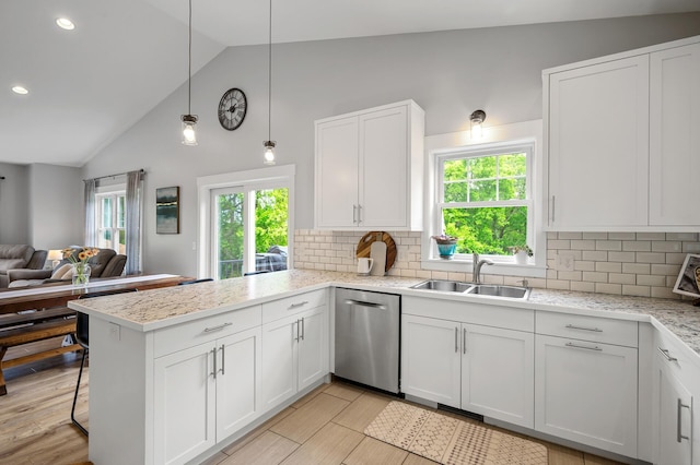 975 100th St NE, Monticello Twp, MN 55362 - kitchen with a sink, dishwasher, a peninsula, open floor plan, and plenty of natural light