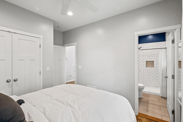 975 100th St NE, Monticello Twp, MN 55362 - bedroom featuring wood finished floors, connected bathroom, a closet, and a ceiling fan