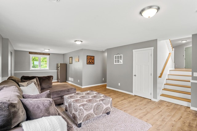 975 100th St NE, Monticello Twp, MN 55362 - living area featuring light wood-style flooring, stairway, and baseboards