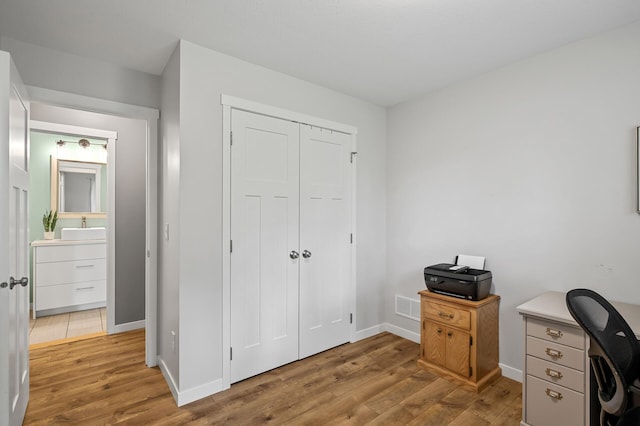 975 100th St NE, Monticello Twp, MN 55362 - office featuring light wood-type flooring, baseboards, and a sink