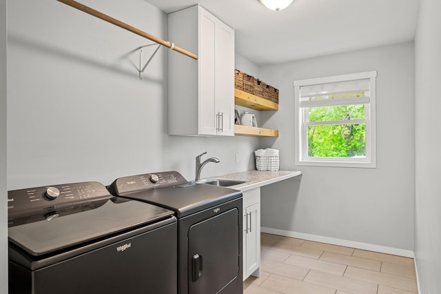 975 100th St NE, Monticello Twp, MN 55362 - laundry area with cabinet space, separate washer and dryer, and baseboards