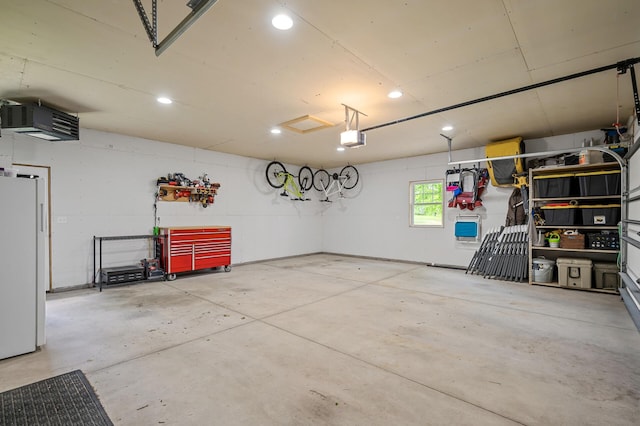 975 100th St NE, Monticello Twp, MN 55362 - garage featuring white refrigerator, recessed lighting, and a garage door opener