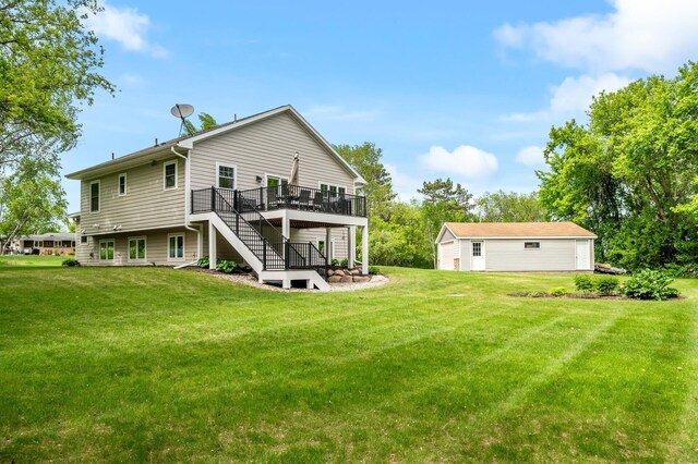 975 100th St NE, Monticello Twp, MN 55362 - back of property featuring stairs, a wooden deck, a lawn, and a detached garage