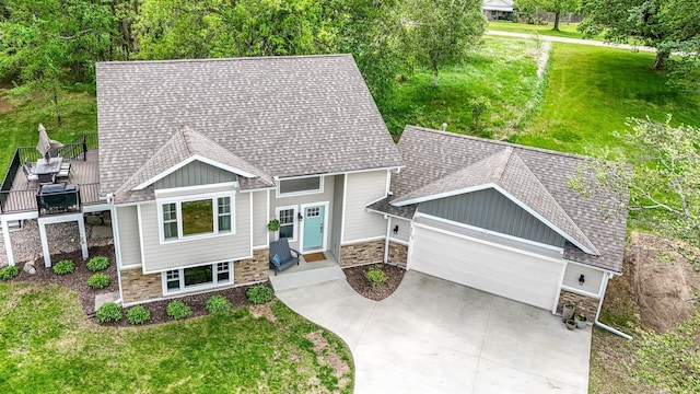 975 100th St NE, Monticello Twp, MN 55362 - craftsman house featuring stone siding, board and batten siding, a garage, roof with shingles, and concrete driveway