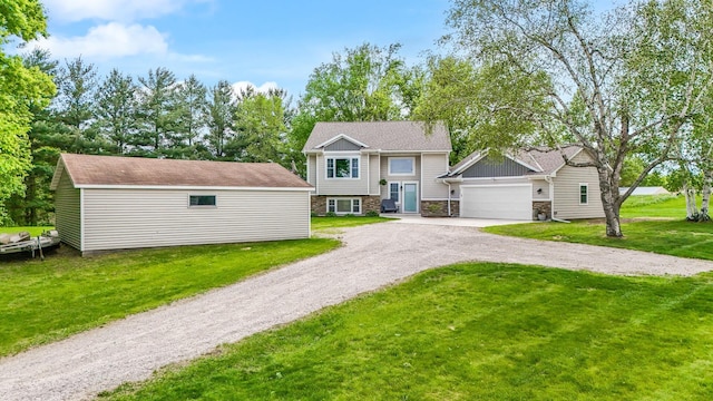 975 100th St NE, Monticello Twp, MN 55362 - view of front of home with an attached garage, dirt driveway, stone siding, and a front yard