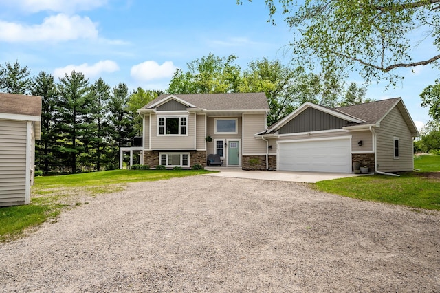 975 100th St NE, Monticello Twp, MN 55362 - bi-level home with driveway, stone siding, an attached garage, and a front yard