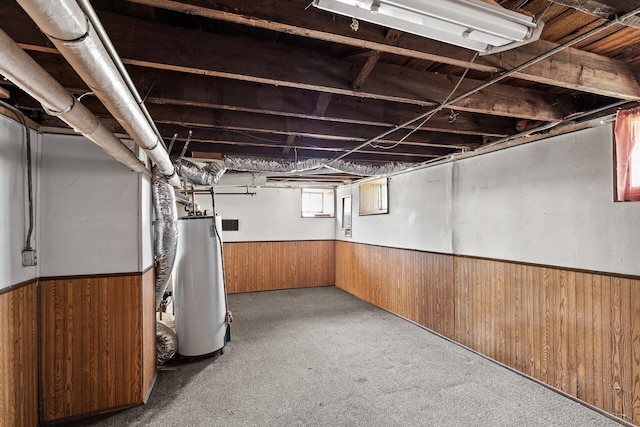 2745 Columbus Ave, Minneapolis, MN 55407 - below grade area with water heater, wood walls, wainscoting, and carpet flooring