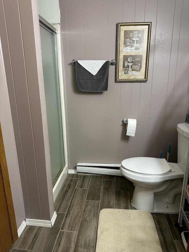 215 1st St NE, Clarks Grove, MN 56016 - full bath featuring wood tiled floors, toilet, a stall shower, and a baseboard heating unit