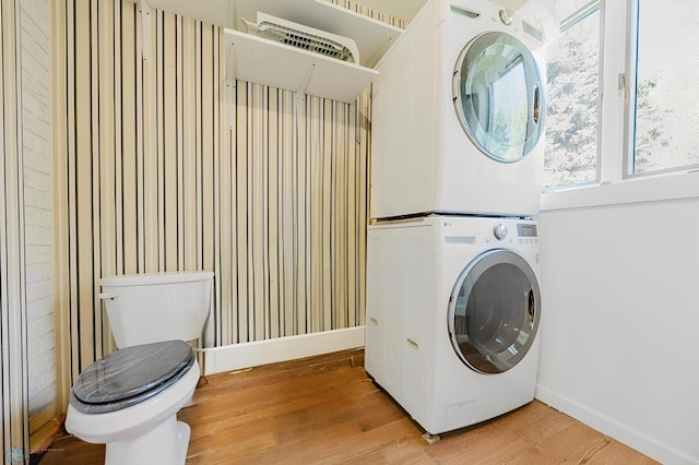 8416 141st Ave SE, Milnor, ND 58060 - laundry area featuring stacked washing machine and dryer, light wood-style flooring, and baseboards
