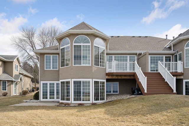 219 Lake Ave S # 4, Spicer, MN 56288 - rear view of house featuring stairway, stucco siding, and a lawn