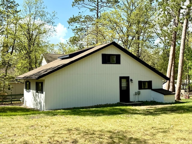 4231 Teal Ln NE, Bemidji, MN 56601 - back of property with a lawn and a shingled roof
