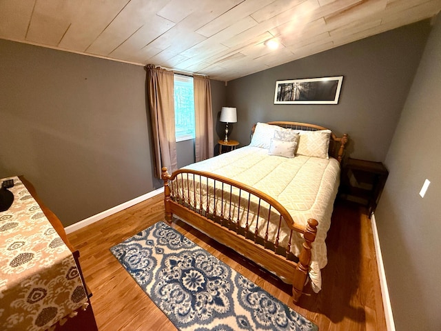 4231 Teal Ln NE, Bemidji, MN 56601 - bedroom featuring lofted ceiling, wood finished floors, and baseboards
