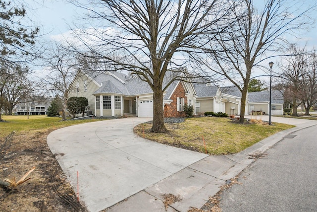 4311 Pond View Dr, White Bear Twp, MN 55110 - traditional home with curved driveway, a front lawn, and an attached garage