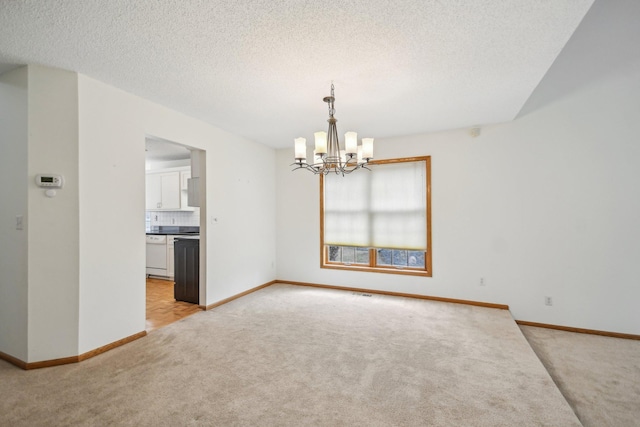 4311 Pond View Dr, White Bear Twp, MN 55110 - spare room featuring light carpet, a chandelier, baseboards, and a textured ceiling