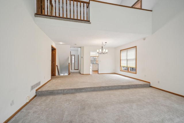 4311 Pond View Dr, White Bear Twp, MN 55110 - unfurnished living room featuring carpet, a chandelier, baseboards, and a high ceiling