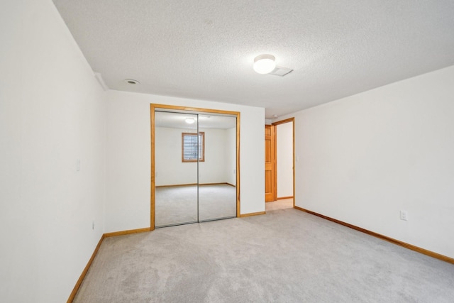 4311 Pond View Dr, White Bear Twp, MN 55110 - unfurnished bedroom featuring light carpet, a textured ceiling, a closet, and baseboards