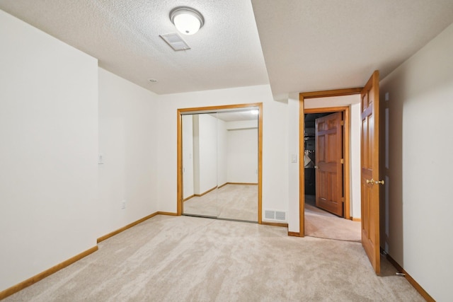 4311 Pond View Dr, White Bear Twp, MN 55110 - unfurnished bedroom with light colored carpet, a closet, baseboards, and a textured ceiling