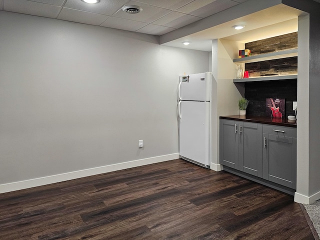 29506 435th Ave, Ottertail, MN 56571 - kitchen featuring freestanding refrigerator, gray cabinets, dark countertops, baseboards, and a paneled ceiling