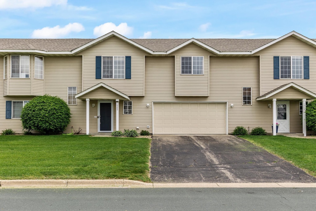 1980 Downing Ave, Shakopee, MN 55379 - view of front of house with driveway, a garage, a front yard, and a shingled roof