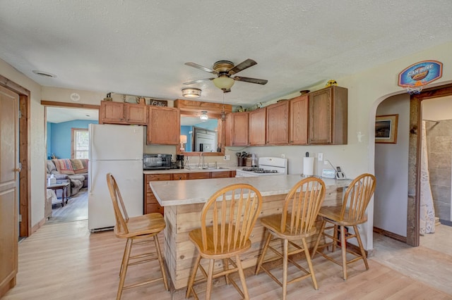 W12517 Southshore Rd, Stubbs Twp, WI 54819 - kitchen with white appliances, a sink, light wood-style flooring, light countertops, and a ceiling fan