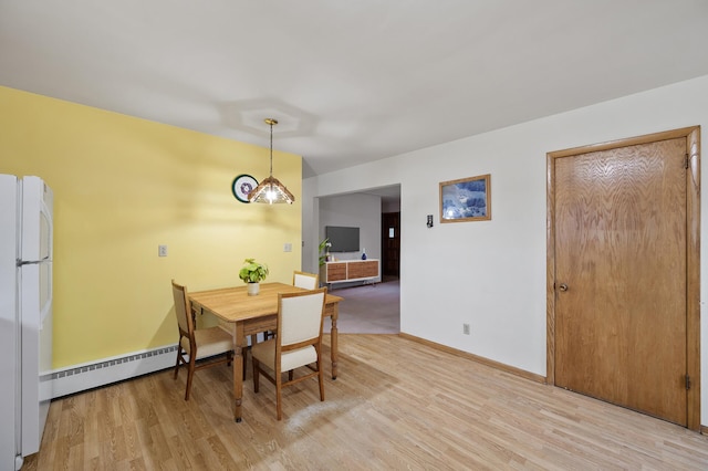 28748 Palm St NW, Isanti, MN 55040 - dining room featuring light wood-style floors, a baseboard radiator, and baseboards