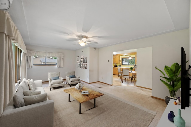 28748 Palm St NW, Isanti, MN 55040 - living room with ceiling fan, baseboards, and light carpet