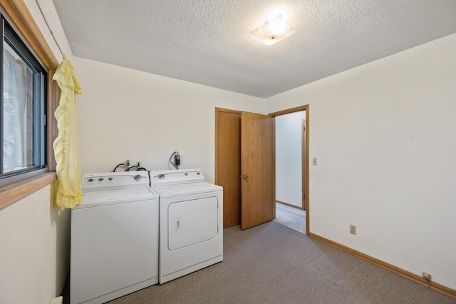 28748 Palm St NW, Isanti, MN 55040 - washroom with separate washer and dryer, light colored carpet, a textured ceiling, and baseboards