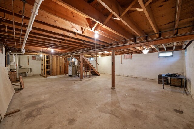 28748 Palm St NW, Isanti, MN 55040 - below grade area with stairs, gas water heater, and a sink