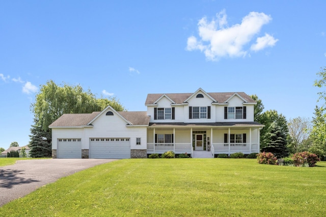 2728 174th Ave NE, Ham Lake, MN 55304 - view of front of property featuring driveway, an attached garage, covered porch, a front yard, and stone siding