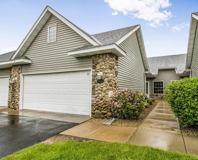15229 Cobalt St NW, Ramsey, MN 55303 - traditional-style home featuring stone siding, a shingled roof, and asphalt driveway