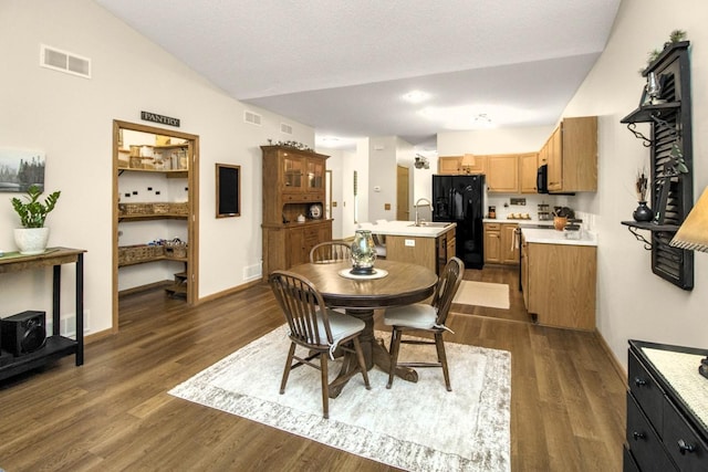 15229 Cobalt St NW, Ramsey, MN 55303 - dining space with dark wood-type flooring, baseboards, and lofted ceiling