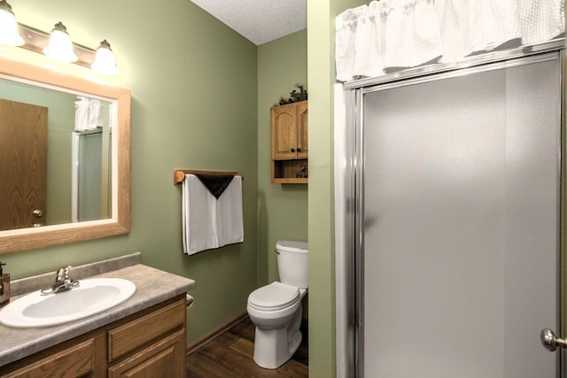 15229 Cobalt St NW, Ramsey, MN 55303 - full bathroom featuring wood finished floors, toilet, a shower stall, and vanity