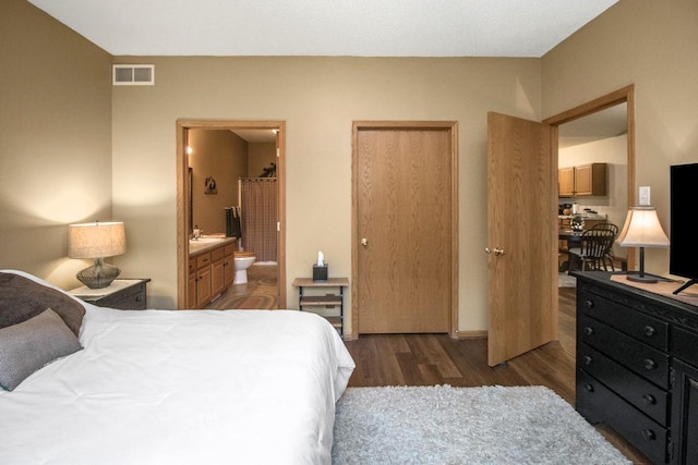 15229 Cobalt St NW, Ramsey, MN 55303 - bedroom featuring wood finished floors, connected bathroom, and a sink