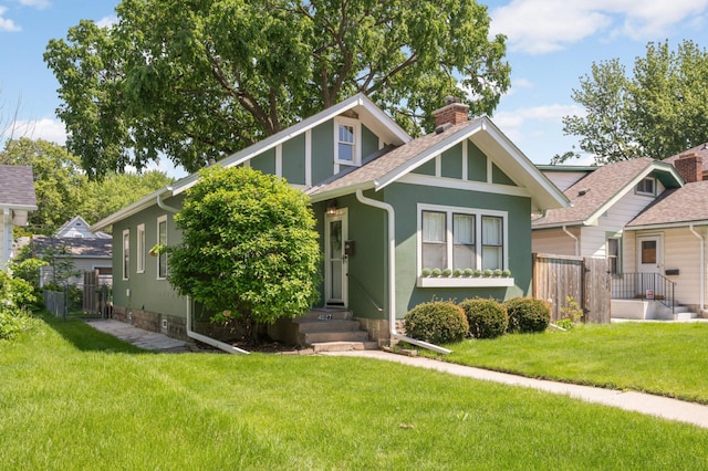4027 24th Ave S, Minneapolis, MN 55406 - view of front of property with a chimney, a shingled roof, and stucco siding