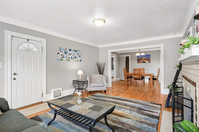 4027 24th Ave S, Minneapolis, MN 55406 - living area with ornamental molding, wood finished floors, a fireplace, baseboards, and a chandelier
